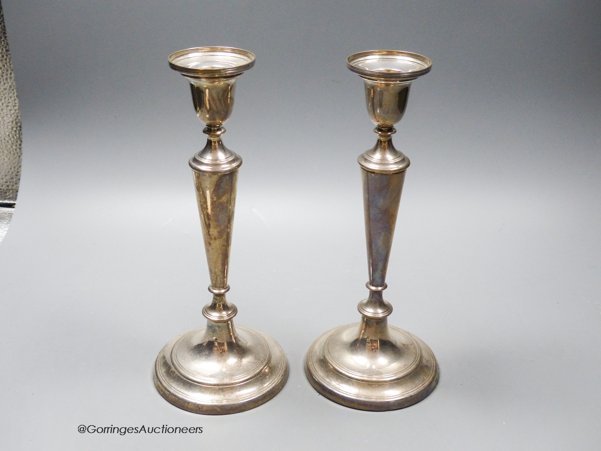 A pair of modern silver candlesticks, London, 1977, 23.1cm, weighted.